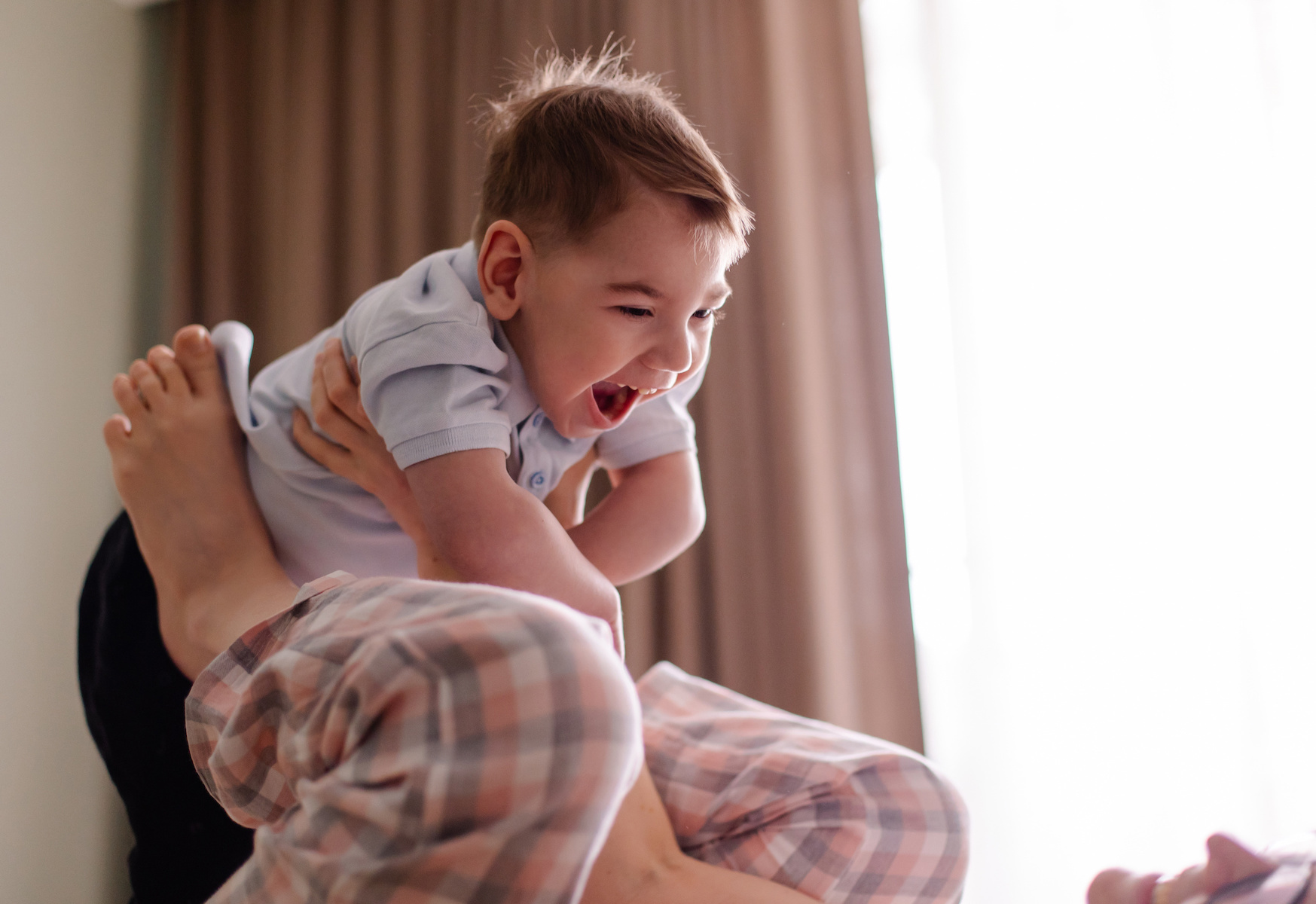 mom of special child plays with him. family with child cerebral palsy lives a normal life. Small moments of happiness real life. Disabled kid toddler laughs smiles. Love caring support.  Lifestyle